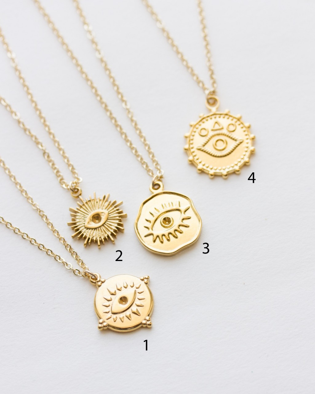 Gold pendant top evil eye